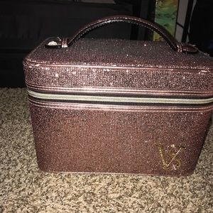 A rose gold shimmer Victoria’s Secret makeup case.